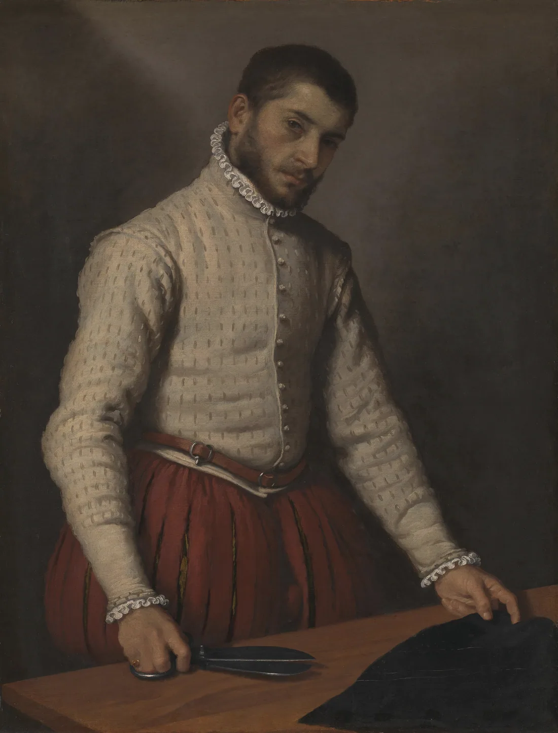 O alfaiate, de Giovanni Battista Moroni (c. 1570): um homem de camisa clara e calções vermelhos, a tesoura numa mão e a outra pousada sobre um tecido preto, em cima da mesa.